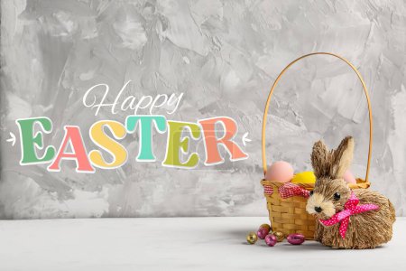 Photo for Beautiful Easter greeting card with basket of eggs and toy bunny - Royalty Free Image