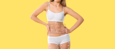 Beautiful young woman in underwear on yellow background. Weight loss concept