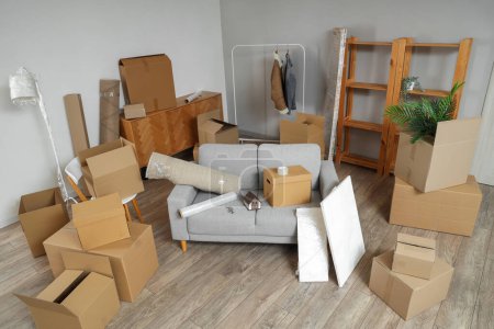Photo for Sofa with cardboard boxes in living room on moving day - Royalty Free Image