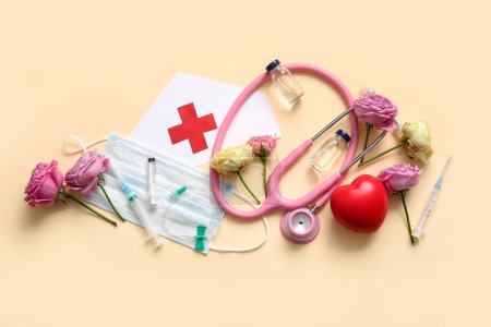 Stethoscope with flowers, syringes and decor for International Nurses Day on beige background
