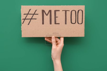 Téléchargez les photos : Femme tenant du papier cartonné avec hashtag METOO sur fond vert - en image libre de droit