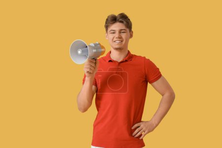 Photo for Male lifeguard with loudspeaker on yellow background - Royalty Free Image