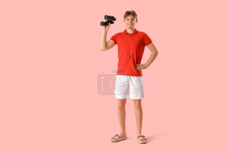 Photo for Male lifeguard with binoculars on pink background - Royalty Free Image