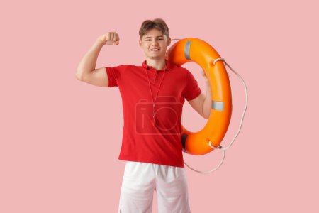 Photo for Male lifeguard with lifebuoy ring on pink background - Royalty Free Image