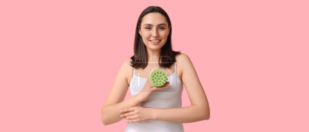 Photo for Beautiful young woman with scalp massager on pink background - Royalty Free Image