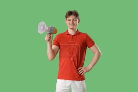 Male lifeguard with loudspeaker on green background