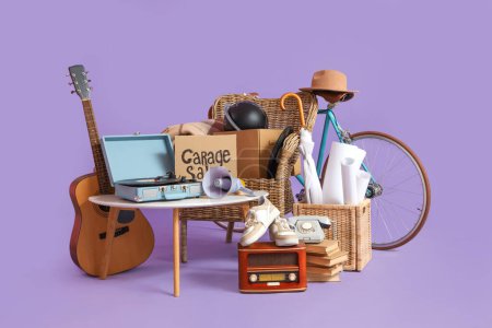Photo for Unwanted stuff for garage sale with table and armchair on lilac background - Royalty Free Image