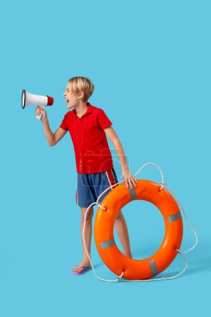 Photo for Little boy lifeguard with ring buoy and megaphone on blue background - Royalty Free Image