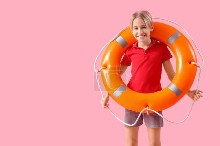 Photo for Happy little boy lifeguard with ring buoy on pink background - Royalty Free Image
