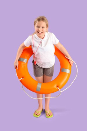 Photo for Happy little girl lifeguard with ring buoy on purple background - Royalty Free Image