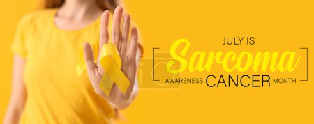 Photo for Woman with yellow ribbon on color background, closeup. Banner for Sarcoma Cancer Awareness Month - Royalty Free Image