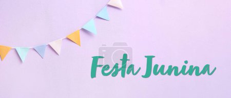Garland and text FESTA JUNINA (June Festival) on lilac background