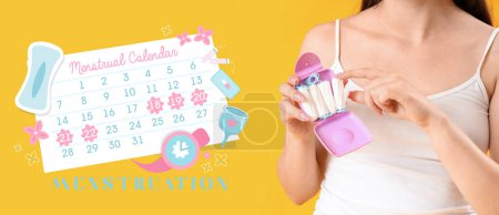 Photo for Young woman holding case with tampons and drawn menstrual calendar on yellow background - Royalty Free Image