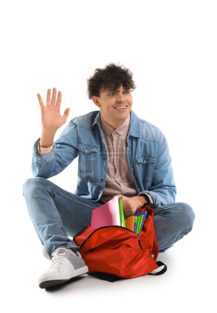 Photo for Male student with backpack waving hand on white background - Royalty Free Image