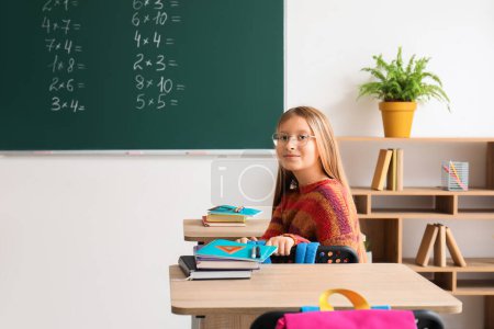 Photo for Little schoolgirl having Math lesson in classroom - Royalty Free Image