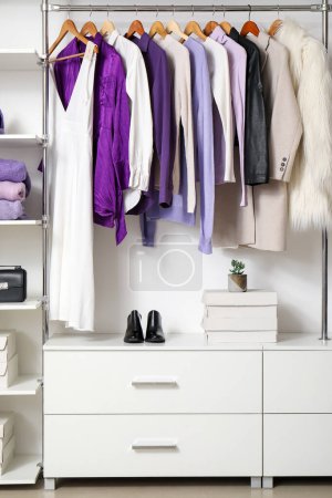 Photo for Rack with clothes and shoes in modern woman's wardrobe - Royalty Free Image