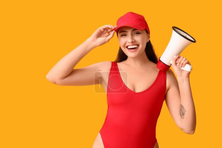 Photo for Female lifeguard with megaphone on yellow background - Royalty Free Image