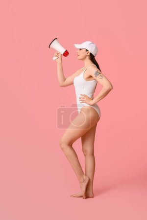 Photo for Female lifeguard with megaphone on pink background - Royalty Free Image