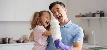 Cute little girl with her dad and pp-duster singing in kitchen