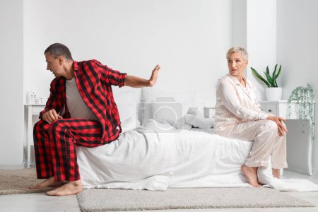 Offended mature couple after quarrel in bedroom