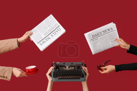 Female hands holding newspapers with vintage typewriter, cup of coffee and smoking pipe on red background