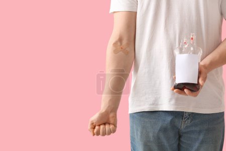 Donor with applied medical patches and blood pack on pink background
