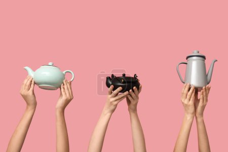 Women with teapots on pink background