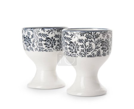 Portahuevos ornamentales de cerámica con flores negras sobre fondo blanco