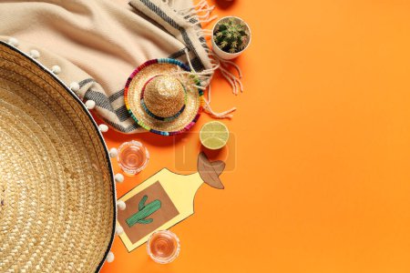 Mexican sombreros with tequila, cactus and decor on orange background. Cinco de Mayo