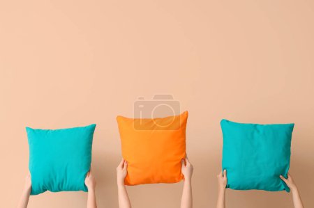 Women with bright pillows on beige background