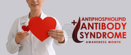 Banner for Antiphospholipid Antibody Syndrome Awareness Month with female dctor holding paper hearts