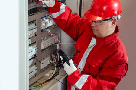 Photo for Electricity and electrical maintenance service, Engineer hand holding AC voltmeter checking electric current voltage. - Royalty Free Image