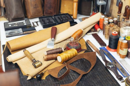 Photo for Tools and leather at cobbler workplace. Set of leather craft tools on wooden background. - Royalty Free Image