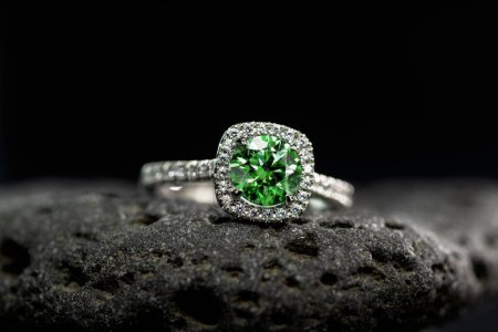 Photo for Engagement gold ring with precious green gemstone - Royalty Free Image