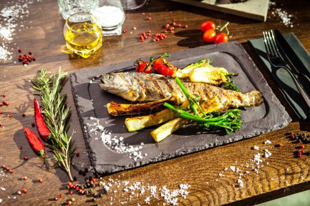 Photo for Rainbow trout grilled. Vegetables, white wine sauce. Delicious healthy traditional food closeup served for lunch in modern gourmet cuisine restaurant. - Royalty Free Image