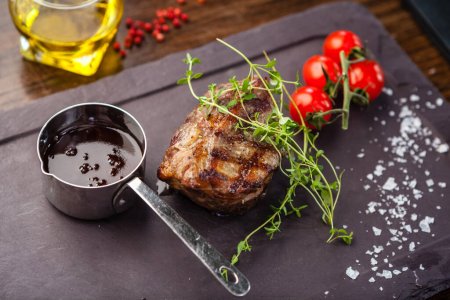 Photo for Lamb steak with cherry tomatoes and wine sauce. Delicious healthy traditional food closeup served for lunch in modern gourmet cuisine restaurant. - Royalty Free Image