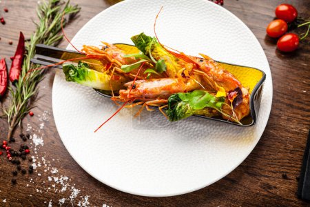 Téléchargez les photos : Crevettes royales argentines, glacées. Chaux, froid et ail. Servi dans une bouteille. Délicieuse cuisine traditionnelle saine servie en gros plan pour le déjeuner dans un restaurant gastronomique moderne. - en image libre de droit