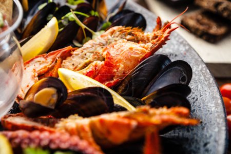 Photo for Seafood platter for 2-4 persons. Lobster, octopus, blue mussels, Argentina king prawns, tuna tartare. Delicious healthy traditional food closeup served for lunch in modern gourmet cuisine restaurant. - Royalty Free Image