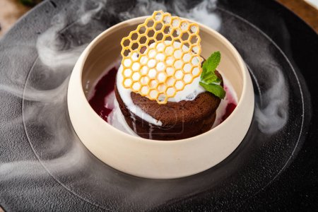 Photo for Chocolate fondant. Dark chocolate, raspberry sauce, vanilla ice cream dessert. Delicious healthy traditional food closeup served for lunch in modern gourmet cuisine restaurant. - Royalty Free Image