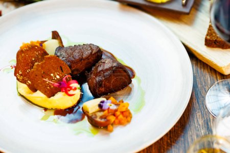 Photo for Deer tenderloin. Truffle-potato puree, porcini mushrooms, baked leek and carrot, juniper bread, port wine sauce. Delicious healthy traditional food served for lunch in modern gourmet restaurant. - Royalty Free Image