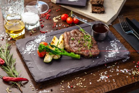 Photo for Black Angus New York steak. Marbled beef sirloin from Uruguay. Delicious healthy traditional food closeup served for lunch in modern gourmet cuisine restaurant. - Royalty Free Image