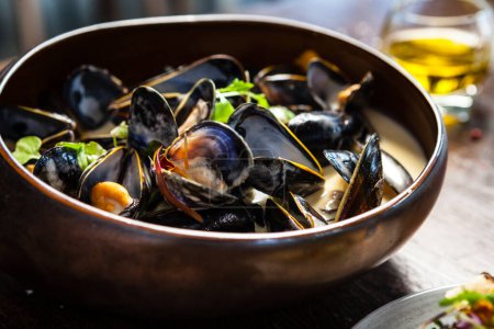 Photo for Blue mussels in cream wine sauce. Delicious healthy Italian traditional food closeup served for lunch in modern gourmet cuisine restaurant. - Royalty Free Image