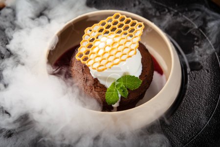 Photo for Chocolate fondant. Dark chocolate, raspberry sauce, vanilla ice cream dessert. Delicious healthy traditional food closeup served for lunch in modern gourmet cuisine restaurant. - Royalty Free Image