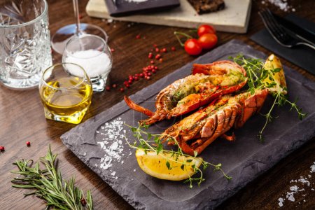 Photo for Lobster with flavored butter. Herb butter, lemon. Delicious healthy traditional food closeup served for lunch in modern gourmet cuisine restaurant. - Royalty Free Image