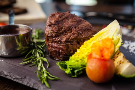 Photo for Black Angus Chateaubriant steak. Tenderloin from Brazil. Delicious healthy traditional food closeup served for lunch in modern gourmet cuisine restaurant. - Royalty Free Image