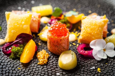Photo for Salted Scottish salmon with trout roe. Marinated cucumber and onion, wonton chips. Delicious healthy Italian traditional food closeup served for lunch in modern gourmet cuisine restaurant. - Royalty Free Image