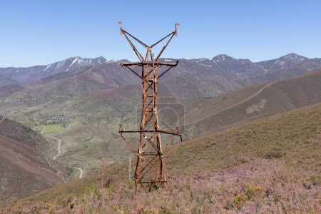 Abandoned metal tower structure in mountain landscape of Asturias Spain on a bright sunny day