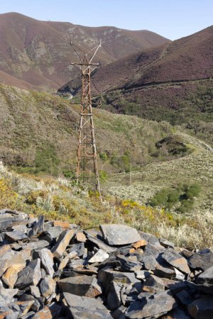 Abandoned metal tower structure in mountain landscape of Asturias Spain on a bright sunny day