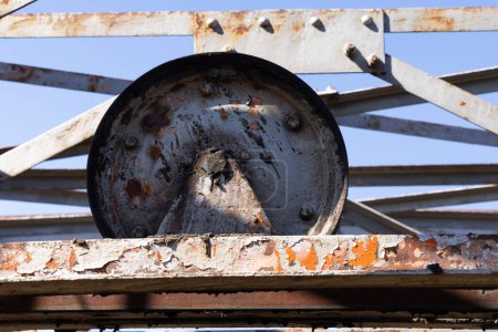 Photo for Abandoned industrial metal rusted wheel for cableway coal mining. - Royalty Free Image