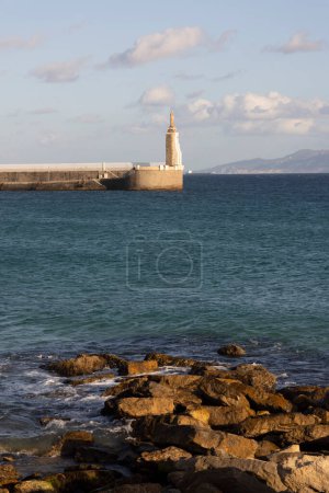 Vertical landscape of Sagrado corazon de Jesus landmark statue in Tarifa on the shore of the Atlantic ocean Girraltar Strait on a bright sunny day with clouds in the bacgkorund.